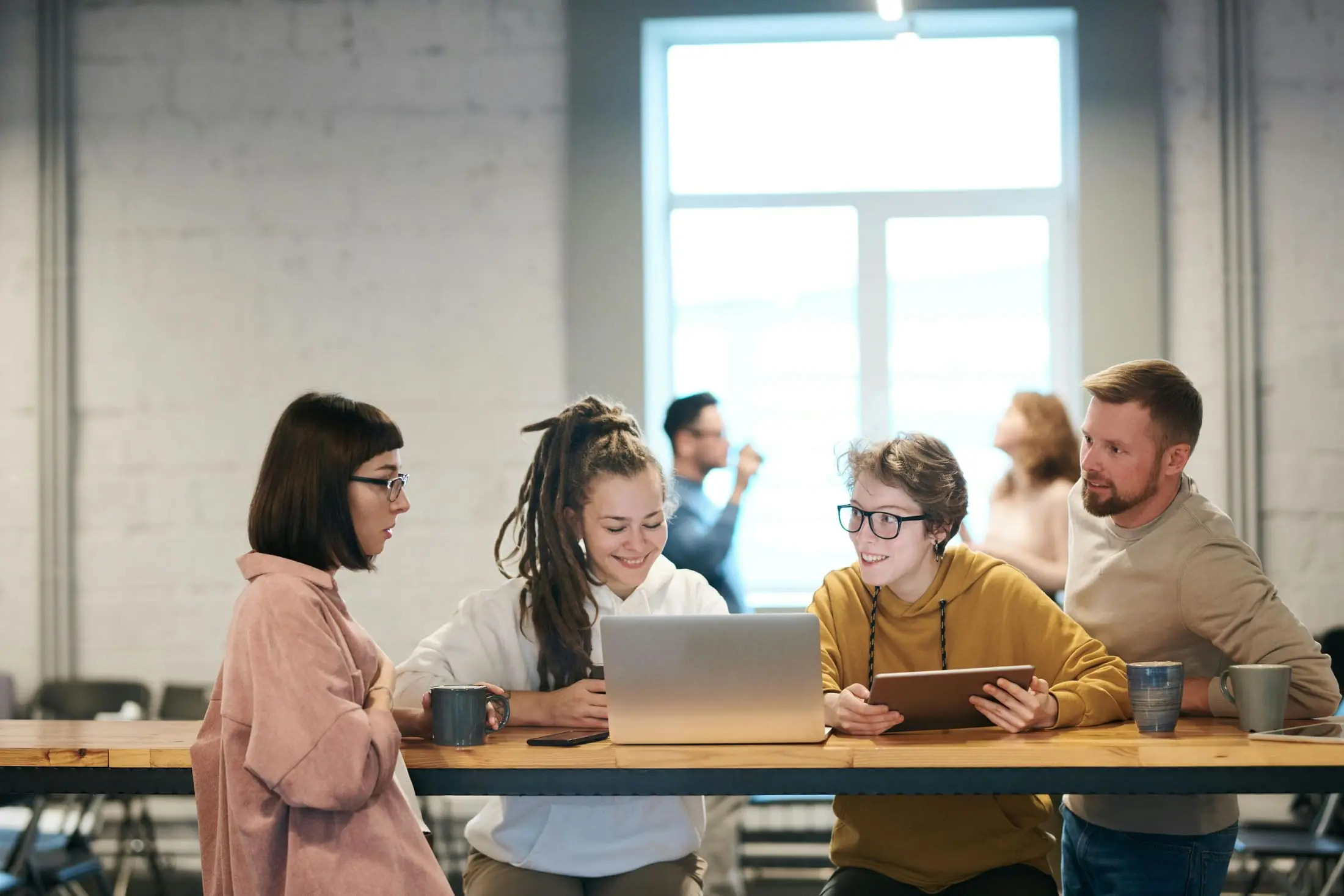 Small group planning together around a laptop